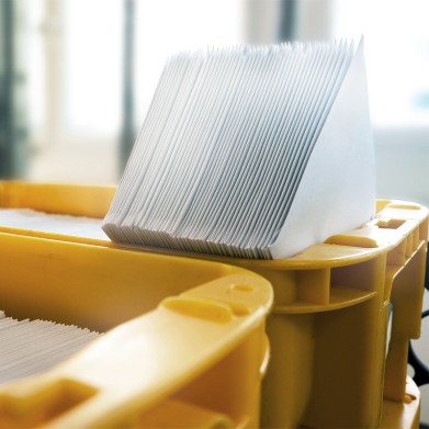 Machine-Inserting Envelopes in yellow boxes